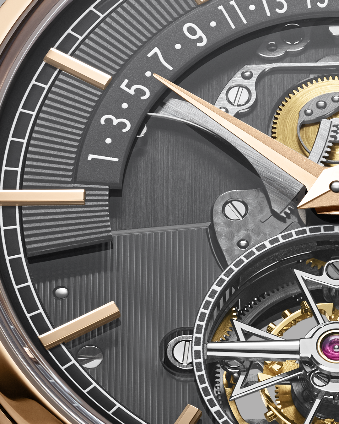 Nửa dưới dành cho lồng tourbillon cắt hình chữ thập Maltese khoét rỗng, nhấn vào ốc vặn màu đen thay cho kim giây nhỏ (small seconds). Những cây kim, bánh răng, cầu nối kết hợp cùng tầng tầng lớp lớp cấu trúc kẻ dọc biến mặt số trở thành trò chơi origami.